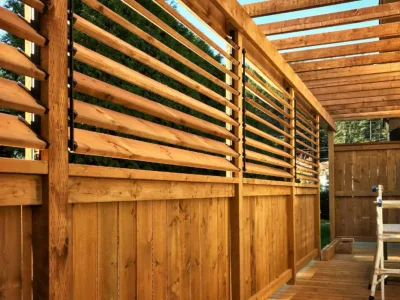 Close-up view of a treated wood privacy wall and pergola