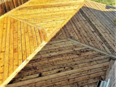 Treated wood deck with wooden fence and grass.