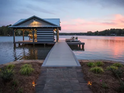Private boat dock with a terrace on a lake during a sunset.