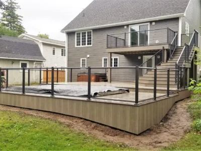 Wooden deck with a pool with steps leading up to a second terrace.