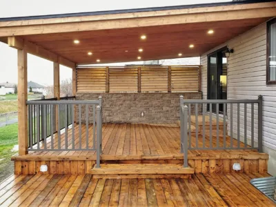 Wooden deck with a privacy wall and a pitched roof.