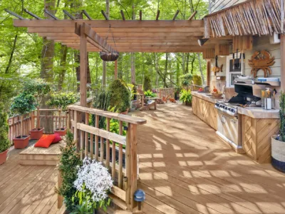 Wood terrace with pergola in a forest setting.