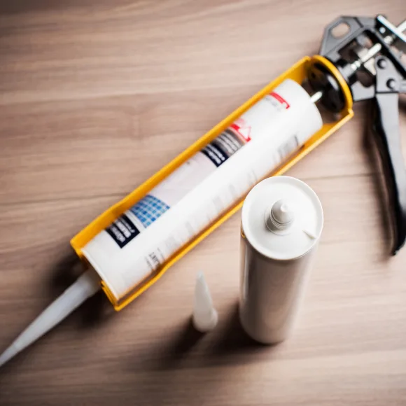 Beauty shoot of a caulking gun with the caulking product.